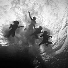 four children are swimming in the water