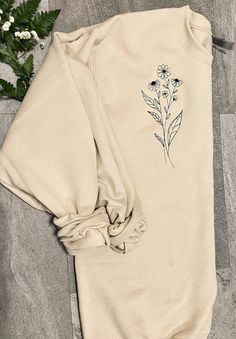 Welcome to Calvin's Street. You will love this long stem flower embroidered sweatshirt.  EMBROIDERY DESIGN   All designs are made with direct embroidery.  Design is embroidered on the left of the front chest.  SWEATSHIRT INFO 7.5 oz., 60/40 cotton/polyester Lined with fleece Unisex sizing SIZING Please look at the sizing chart in my product photos for measurements. If the size you need is sold out message me so I can check to see if my supplier offers/has your size! EMBROIDERY THREAD CARE 1. For best results, wash in warm water with a mild detergent. 2. Do not add bleaching agents such as chlorine, peroxide or sodium carbonate. 3. Do not line dry. Garments should be tumble dried at warm setting. 4. Never leave damp or wet embroidered articles folded or stuck together. 5. Never wring out an Embroidered Long Sleeve Sweatshirt For Spring, Spring Long Sleeve Sweatshirt With Floral Embroidery, Spring Floral Embroidery Long Sleeve Sweatshirt, Spring Floral Embroidered Long Sleeve Sweatshirt, Spring Sweatshirt With Custom Embroidery And Relaxed Fit, Fall Cotton Sweatshirt With Floral Embroidery, Spring Sweatshirt With Custom Embroidery In Relaxed Fit, Spring Embroidered Long Sleeve Sweatshirt, Spring Cotton Sweatshirt With Floral Embroidery