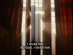 a person standing in front of a window with the words i loved him by god, i loved him