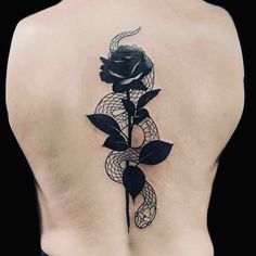 a black rose tattoo on the back of a woman's upper and lower back