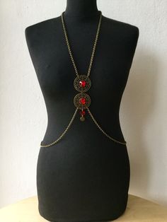 summer, bodychain, handmade bodychain, custom necklace, bodynecklace, body jewellery, crystal necklace,silver bodychain, handmade necklace, It is handmade, and its design is inspired by mandalas. The chain is bronze, and at the center on the chest it has two figures of filigree adorned with a red brilliant crystal in the center. Take a look at our different models of mandala bodychains, they are comfortable, and lightweight. You can use them every day to brighten any outfit and give it a special Bohemian Body Jewelry With Beaded Chain For Party, Bohemian Body Jewelry With Chain For Summer, Bohemian Beaded Chain Body Jewelry For Party, Bohemian Summer Body Jewelry Chain, Bohemian Body Jewelry With Adjustable Chain, Bohemian Body Jewelry With Adjustable Chain For Summer, Summer Festival Metal Body Jewelry, Metal Adjustable Body Chain For Festivals, Bohemian Body Jewelry With Chain For Festivals