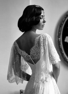 black and white photograph of a woman in a wedding dress looking off into the distance