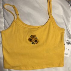 Women’s Hollister Yellow Baby Cami/Crop Top With Adjustable Straps & Embroidered Sunflower On The Front. Nice Yellow Color And Material Is Thick Enough You Could Go Braless. Size Xs. Cute Floral Embroidery Summer Tops, Casual Fitted Tank Top With Floral Embroidery, Fitted Casual Tank Top With Floral Embroidery, Casual Fitted Floral Embroidery Tank Top, Fitted Casual Top With Sunflower Print, Fitted Yellow Tops With Sunflower Print, Fitted Sunflower Print Top For Summer, Sunflower Print Beach Tops For Summer, Fitted Sunflower Print Top For Spring