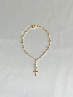 A stunning bracelet featuring a dainty cross drop beaded chain and 18k gf stamp. An absolute essential in every jewelry collection. - 18k gold filled - Water resistant - Will not rust or tarnish - Spring ring clasp closure - Select desired size in dropdown menu Rosary Bracelet Gold, Gold Rosary Bracelet, Virgin Mary Bracelet, Catholic Rosary Bracelet, Gold Rosary, Preppy Chic, Catholic Jewelry, Religious Cross, Rosary Bracelet