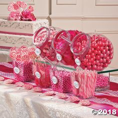 a table topped with lots of candy and lollipops on top of it