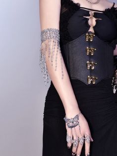 Elevate your cyberpunk style with our silver gothic tassels beads armlet. This unique piece features intricate tassels and beads, adding a touch of edgy elegance to any outfit. Made for individual purchase, this armlet is a must-have accessory for anyone looking to embrace the cyberpunk aesthetic. Stand out from the crowd and make a bold fashion statement with this striking armlet.  Please note that this product includes only one armlet. Punk Body Jewelry For Halloween Party, Adjustable Punk Body Jewelry For Party, Edgy Silver Body Jewelry For Festivals, Edgy Silver Metal Body Jewelry, Silver Punk Body Jewelry For Party, Gothic Metal Body Jewelry For Party, Edgy Silver Beaded Jewelry, Edgy Adjustable Body Jewelry For Parties, Adjustable Edgy Body Jewelry For Parties