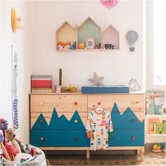 a child's room with a dresser and toys