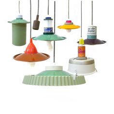 several different colored lamps hanging from hooks