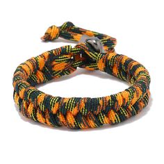 an orange, black and yellow rope bracelet with silver clasps on a white background