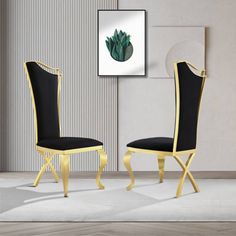 two black and gold chairs in front of a wall