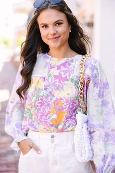 Add a touch of femininity to your work attire with this floral blouse! This blouse features a tasteful floral design, perfect for maintaining a professional yet stylish appearance in any workplace setting. This blouse features a round neckline, long bubble sleeves, a floral print, and crochet detailing around the shoulders.  Material has no amount of stretch.Sydney is wearing the small. Lavender Tops, Floral Cocktail Dress, Black Tie Dress, Long Sleeve Outerwear, Two Piece Swimwear, Friend Outfits, Lavender Purple, Romper With Skirt, Work Attire