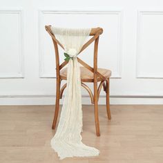 a chair with a flower on it and a white cloth draped over the back of it