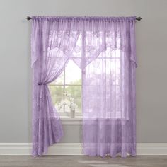 a purple curtain hanging on the side of a window