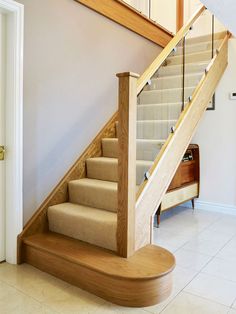 the stairs are made of wood and beige carpet