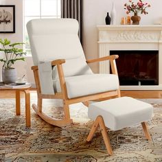 a white rocking chair and ottoman in a living room