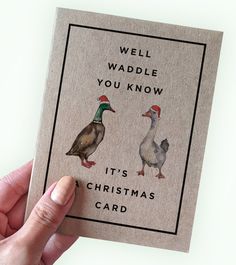 a hand holding a card with two ducks on it and the words well waddle you know, it's christmas card