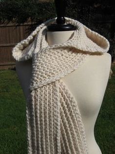 a white knitted scarf sitting on top of a mannequin's dummy