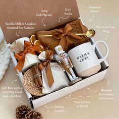 the contents of a gift box with coffee mugs, cookies and other items in it