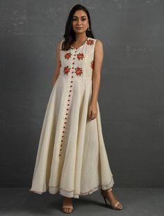 A double-layered umbrella cut front open Chanderi kurta with all-over floral buttis in yoke made using beads, sequins and silk French knots. Beadwork runs along the neckline and armhole. Contrast buttons and scalloped edges embroidered double layered flared hemline. The kurta comes with a delicate chanderi dupatta with all over sequence work and a wide woven zari border at the hem. Kurta measurements (in Inches): Size S: Bust - 38", Waist - 35", Length: 52" Size M: Bust - 40", Waist - 37", Lengt Traditional Sleeveless Embroidered Dress For Festive Occasions, Traditional Sleeveless Embroidered Dress, Festive Sleeveless Chanderi Dress, Traditional Sleeveless Embroidered Festive Dress, Chanderi Sleeveless Dresses For Festivals, Designer Sleeveless Raw Silk Kurta, Sleeveless Chanderi Anarkali Dress, Summer Anarkali Set With Floral Embroidery, Cotton Wedding Dress With Mirror Work