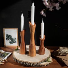 three wooden candles are sitting on a table