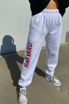 A must have! Stay comfy all season long in the our Harvard Basic Sweatpants. These sweatpants feature a high-rise fit, elastic waistband, side pockets, and cuffed ankles. High-rise Elastic waistband Side pockets Cuffed ankles 75% Cotton, 25% Polyester Machine washable Size + Fit Wearing size S Height: 5'5" P.S. We'd love to see you repping this style! Don't forget to tag us to be featured ♡ *All MTO orders are made specifically for you. Please allow 3-6 business days for order to be processed an Ohio State Outfit, College Items, Black Tube Tops, College Clothes, White Tennis Skirt, College Aesthetic, Class Of 2025, Fleece Sweatpants, Fashion Outfit Ideas