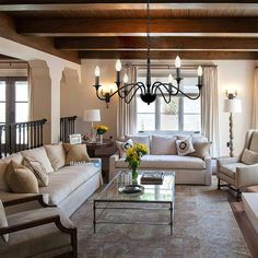 a living room filled with furniture and a chandelier