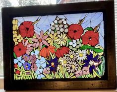 a stained glass window with flowers on it