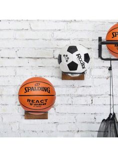 three basketballs are hanging on the wall