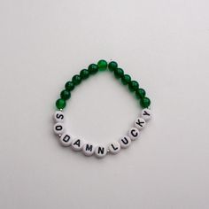 So Damn Lucky bracelet. Please note size:  5 - 5.5 inches small (kids)  6.5 standard  7.5-8.5 large/ men's sizes Green Novelty Bracelets With Round Beads, Green Novelty Jewelry With Round Beads, Green Round Beads Novelty Jewelry, Green Letter Beads Jewelry For Birthday, Green Jewelry With Letter Beads For Birthday, Green Novelty Jewelry With Letter Beads, Customizable Green Name Bracelet Gift, Casual Customized Green Jewelry, Green Personalized Bracelets With Round Beads