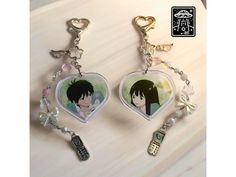 two key chains with anime characters on them