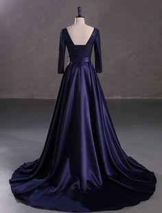 a dress on a mannequin with an open back and long sleeves in blue