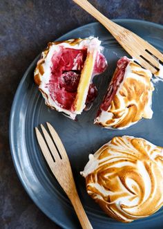 two pastries on a blue plate with wooden utensils