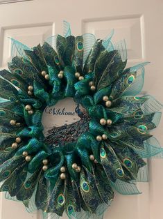 a peacock wreath is hanging on the front door