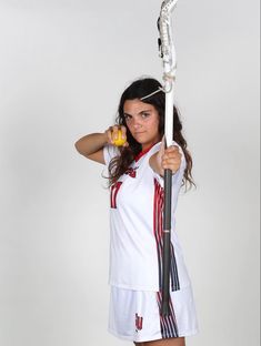 a woman holding a tennis racquet on top of her shoulder