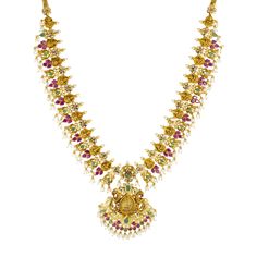 Adorn yourself with the splendor of traditional Indian jewelry craftsmanship on your wedding day by wearing this exquisite 22k gold necklace and earrings set by Virani Jewelers. With its stunning display of emeralds, rubies, pearls and cubic zirconia, and superior craftsmanship, this 22k gold bridal jewelry set is a true masterpiece of fine jewelry. Indulge in the opulence of gold and gemstones and elevate your wedding ensemble with these temple-style Chandbali earrings and necklace by Virani Je Multicolor 17 Jewels Temple Necklace, Multicolor Temple Necklace With 17 Jewels, Festive 22k Yellow Gold Emerald Necklace, Multicolor Temple Necklace With 17 Jewels For Wedding, Bollywood Style Hand Set Yellow Gold Temple Necklace, Heavy 22k Gold Temple Necklace For Celebrations, Temple Jewelry Necklace With 17 Jewels For Wedding, Multicolor 22k Gold Bridal Necklace For Celebration, Temple Necklace With 17 Jewels For Wedding