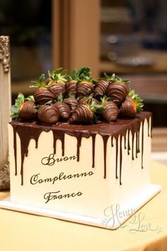 a chocolate covered cake sitting on top of a table