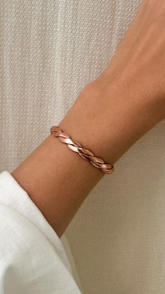 Discover the timeless elegance of this handcrafted pure copper braided cuff bracelet, meticulously designed and created by skilled artisans. This exquisite piece features a unique braided pattern, offering a blend of traditional craftsmanship and modern style. Key Features: Material: 100% Pure Copper Design: Intricate Braided Pattern Handmade: Each bracelet is individually crafted by artisans Adjustable: Easily fits most wrist sizes Benefits: Known for potential health benefits such as improved Gold Copper Cuff Bracelet Gift, Unique Gold Cuff Bracelet In Copper, Luxury Hand-forged Cuff Bracelet, Elegant Copper Cuff Bracelet, Adjustable Brass Cuff Bracelet, Spiritual Style, Braid Cuffs, Secret Message Bracelet, Copper Design, Message Bracelet