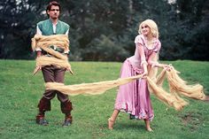 a man and woman dressed up as rappui and princesses with long hair