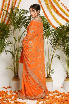 Orange pure chiffon saree with jaal pattern of Salma sitara with zardozi hand embroidery. Paired with blouse.
Component: 2
Pattern: Embroidered
Type Of Work: Floral
Sleeve Type: Tassel Sleeves
Fabric: Pure Chiffon
Color: Orange
Other Details: 
Zardozi work
Floral motifs
Note: Bag shown in the image is not for sale
Occasion: Wedding - Aza Fashions Georgette Pre-draped Saree With Dupatta For Diwali, Orange Silk Dupatta For Reception, Orange Dupatta For Reception And Festivals, Orange Chanderi Dupatta For Reception, Georgette Pre-draped Saree With Cutdana, Pre-draped Saree With Cutdana For Eid, Orange Dupatta For Diwali Reception, Orange Dupatta For Reception And Diwali, Floor-length Pre-draped Georgette Saree With Cutdana