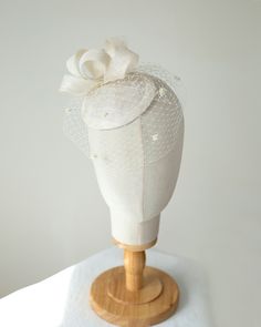 The millinery bridal hat is made of sinamay trimmed with bow trimming and birdcage veil. The veil on this pillbox is adorned with sweet little chenille dots. The hat attaches to the hair with flat hair comb from bottom side for easy placement to any hair style. Colours: light ivory (as pictured)  Also available in white, cream, lilac or beige sinamay for brides, black or navy for special occasion I make all my hats and trimmings using traditional millinery couture technique and patterns (not pre Fitted Tulle Fascinator For Kentucky Derby, Elegant Wedding Hats With Satin Bow, Elegant Cream Tulle Veil, Tulle Fascinator For Royal Ascot, Elegant Tulle Fascinator On Headband, Elegant Tulle Fascinator Headband, Tulle Hat For Weddings And Kentucky Derby, Fitted Tulle Hats For Weddings, Adjustable Fascinator For Wedding