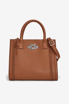 A modern mid-size tote with a beautiful bumped border features a refined textural herringbone laced design and bold Harmony knot hardware gives it that extra special detail. It’s modern yet classic. It can be handheld or worn with its adjustable crossbody strap. Mid Size, Lace Design, Crossbody Strap, Herringbone, Knot, Lace, Design