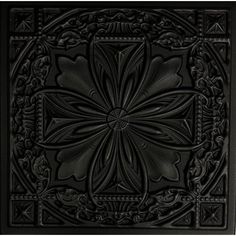 a black square tile with an intricate flower design on the center and sides, surrounded by decorative elements