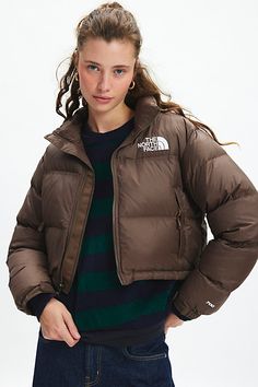 The iconic The North Face 1996 Retro Nuptse down puffer jacket made modern in a cropped puffer jacket silhouette. The North Face Nuptse short down puffer jacket is crafted from durable water-repellent recycled nylon with ultra-warm 700 down fill in a cropped boxy puffer jacket silhouette. Finished with an adjustable drawcord hem and zip-front closure. This cozy puffer jacket has an attached stowable hood, and zipped hand pockets. Features The North Face Nuptse short jacket Cropped version of the The North Face Long Sleeve Down Puffer Jacket, The North Face Down Puffer Jacket, The North Face Down Puffer Jacket With Padded Collar, Cropped Puffer Outerwear For Fall, Fall Cropped Puffer Outerwear, The North Face Puffer Jacket For Cold Fall Weather, The North Face Nylon Outerwear For Fall, Casual The North Face Puffer Jacket For Fall, The North Face Fall Puffer Jacket With Pockets