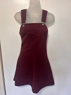 "Amazing vintage dress from the 70's!  Kandel Knitting Mills: Portland Oregon 100% Polyester - thick maroon.  Overall jumper with one pocket in front.  Adjustable straps  Zipper in back - does have some stretch Midi length In Excellent Vintage Condition with no visible flaws.  Measurements: Bust: 30\" - I was able to stretch into this at 34\" Waist: 28\" Length: 27\"" Fitted Fall Pinafore Dress With Pockets, Fitted Casual Pinafore Dress For Fall, Fitted Cotton Pinafore Dress For Fall, Fitted Sleeveless Vintage Suspender Dress, Fitted Sleeveless Pinafore Dress For Fall, Fitted Mini Length Pinafore Dress For Fall, Fitted Sleeveless Pinafore Dress With Pockets, Casual Fitted Suspender Dress For Fall, Vintage Sleeveless Pinafore Dress For Fall