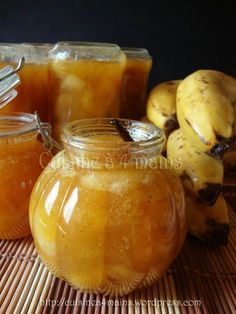 jars filled with honey sit next to bananas