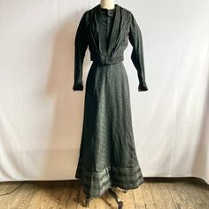 Edwardian Walking Suit Consisting Of Jacket And Skirt In A Black Wool Crepe (?), With A Subtle Floral Weave. The Fabric Has A Somewhat Crinkly Texture And Some Stretch. Bordered In Bands Of Soutache, With Additional Soutache And Braiding Down Bodice And At Sleeve Cuffs. Jacket Has Deep V Neck To Tudor Waist, Where It Fastens With Hooks And Eyes. Jacket Is Lined In Boned, Black Polished Cotton That Closes With Hooks & Eyes And Has Band Of Fabric At Neckline, With No Closure. Princess Seams At Bac Black Fitted Long Sleeve Skirt Suit, Tailored Black Skirt Suit For Fall, Tailored Black Sets For Fall, Fitted Black Sets For Fall, Black Long Sleeve Skirt Suit For Evening, Formal Black Long Sleeve Skirt Suit, Black Long Sleeve Skirt Suit For Formal Occasions, Tailored Black Long Sleeve Sets, Black Tailored Long Sleeve Sets