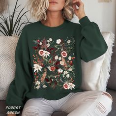 Introducing our Fall& Winter Cottage Core Sweatshirt, a charming blend of style and nature. This cozy sweater is adorned with a mix of painted fall and winter flowers, berries, and both dried and pressed flowers ( painted & real), bringing the warmth of nature to your wardrobe during the colder months. Made with air-jut spun yarn for a soft feel, this pre-shrunk, classic fit sweater is both stylish and comfortable. Perfect for nature enthusiasts, Cottagecore lovers, and anyone who appreciates the charm of pressed flowers. So pick one for yourself of your loved onces and embrace the beauty of nature during the colder months. PRODUCT SPEC. * 50% cotton, 50% polyester * Pre-shrunk * Classic fit * 1x1 athletic rib knit collar with spandex * Air-jet spun yarn with a soft feel * Double-needle st Witch Sweater, Winter Cottagecore, Winter Cottage, Flowers Painted, Dried And Pressed Flowers, Winter Flowers, Sweater Gift, Cozy Sweater, Gifts For Nature Lovers