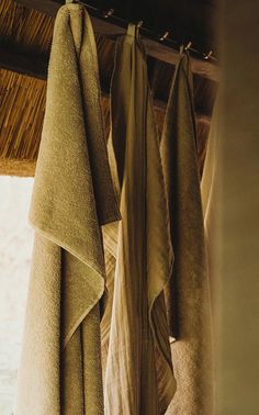 towels hanging from the ceiling in front of a window