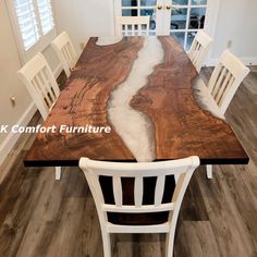 a wooden table with white chairs around it