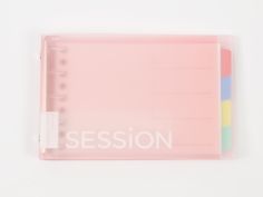 a pink binder with the word session written in white on it's side